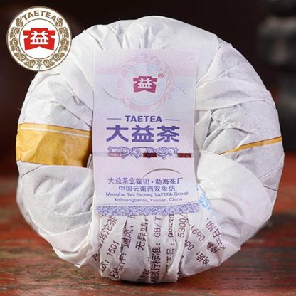 Dayi Menghai tea factory ripe Puerh Tuo in wrapper on a table