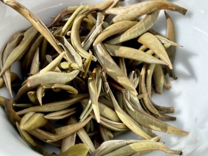 A close up off used chi obese white tea leafs in a bowl