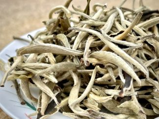 Close up of Yunnan, silver bud white tea on a bowl