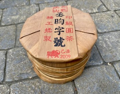 A tong of raw puerh tea cakes on the driveway