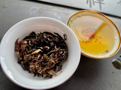 Gushu a black tea in a gaiwan and a full tea cup on the table