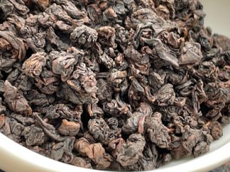Are you close up of charcoal roast Tie Guan Yin Oolong tea in a bowl
